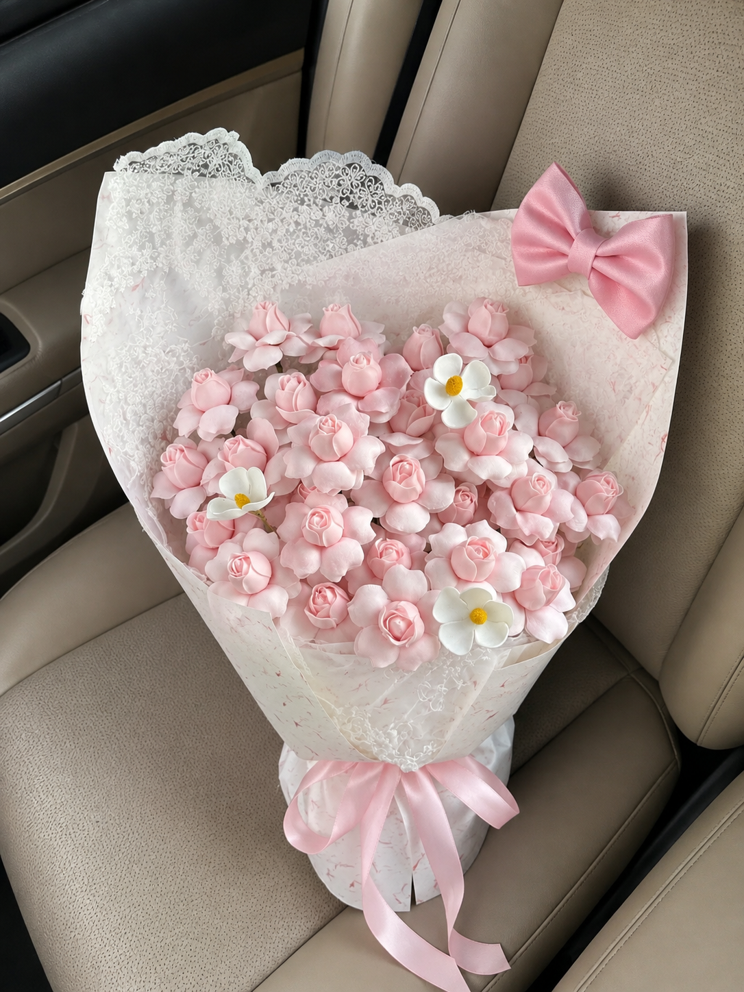 Birthday Pink Blossom Bow Bouquet – high-angle bouquet on parked car seat