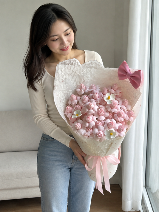 Birthday Pink Blossom Bow Bouquet – AI-assisted model holding bouquet at an angle
