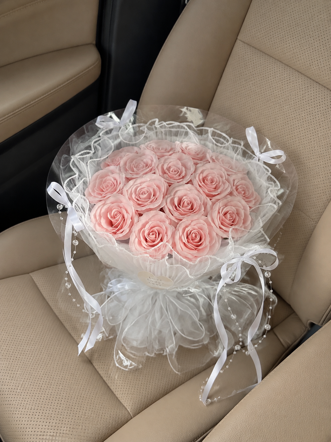 Pink Rose Pearl Ruffle Bouquet — overhead car-seat view; AI-assisted design illustration