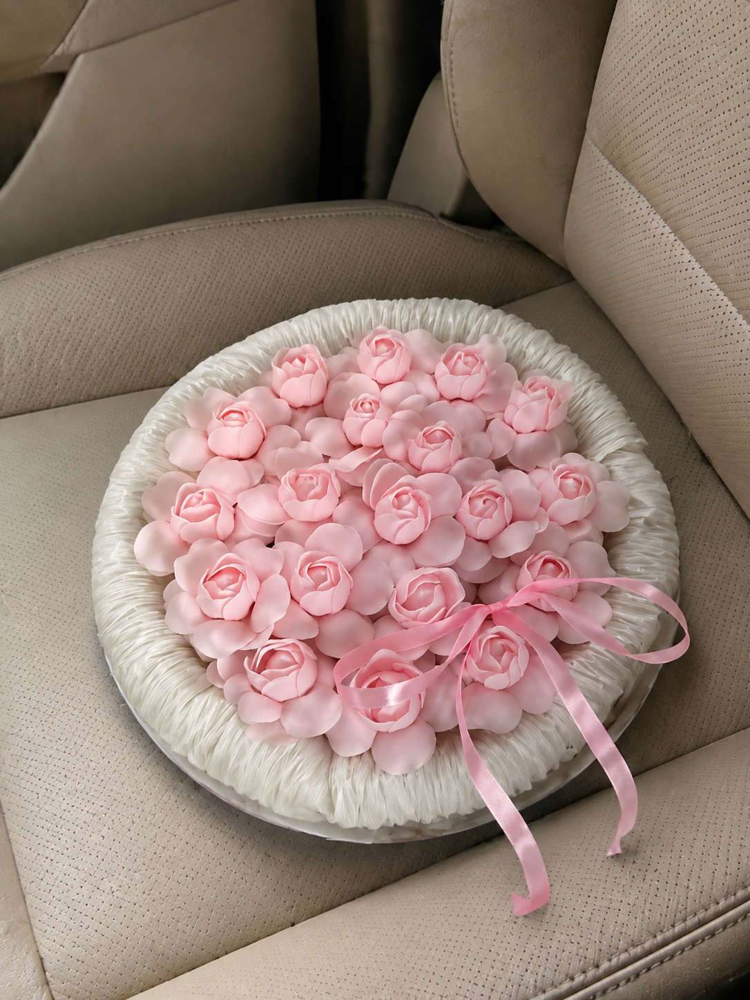 Pink Rose Round Frame Gift Bouquet – high-angle bouquet view on parked car seat