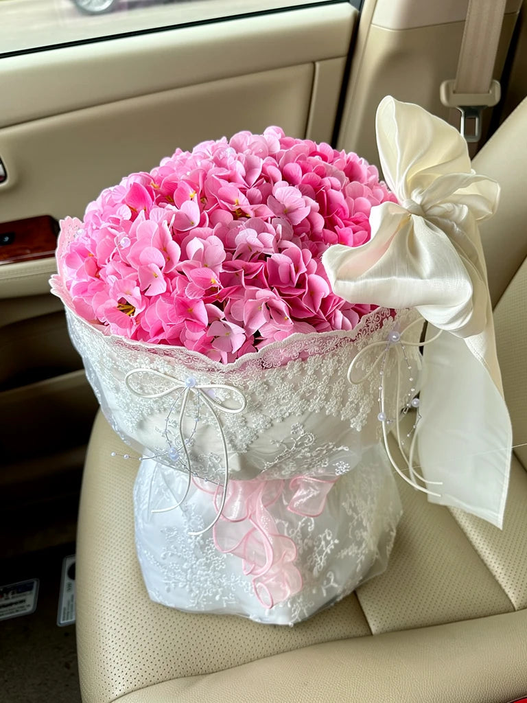 Hot Pink Hydrangea Lace Bouquet, Medium, high-angle car-seat view; AI lifestyle illustration