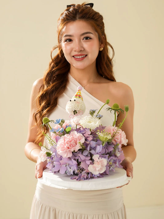 Nguyen Lan holding Lilac Cloud Party Flower Cake, Medium; AI lifestyle illustration