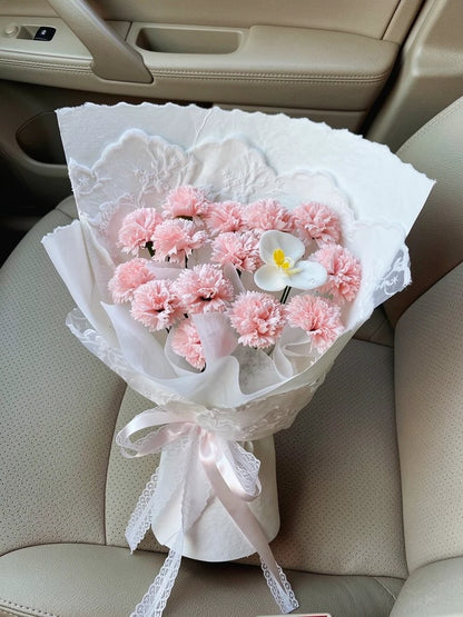Blush Carnation Frangipani Bouquet, Medium, high-angle car-seat view; AI lifestyle illustration