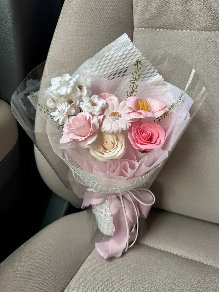 High-angle view of Blush Meadow Small Flower Bouquet on a parked-car passenger seat; AI lifestyle illustration