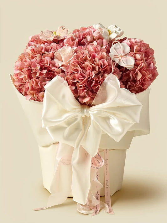 Front view of Blush Reverie pink silk-style hydrangea bouquet with ivory bow; AI design illustration