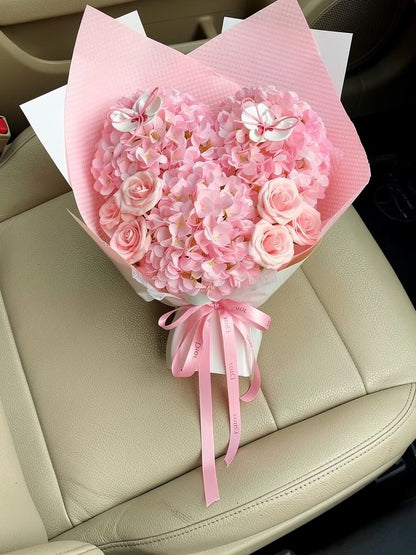 Butterfly Heart Pink Hydrangea Bouquet, Medium, high-angle car-seat view; AI lifestyle illustration