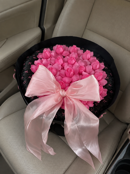Hot Pink Rosebud Midnight Bow Bouquet – high-angle bouquet on parked car seat