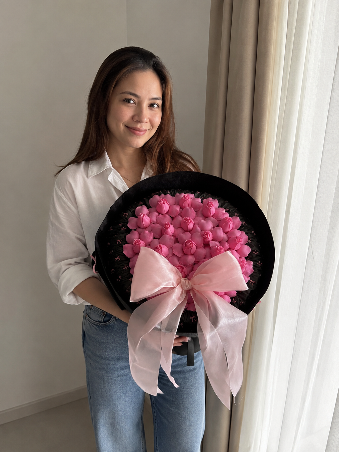 Hot Pink Rosebud Midnight Bow Bouquet – AI-assisted model holding bouquet at an angle