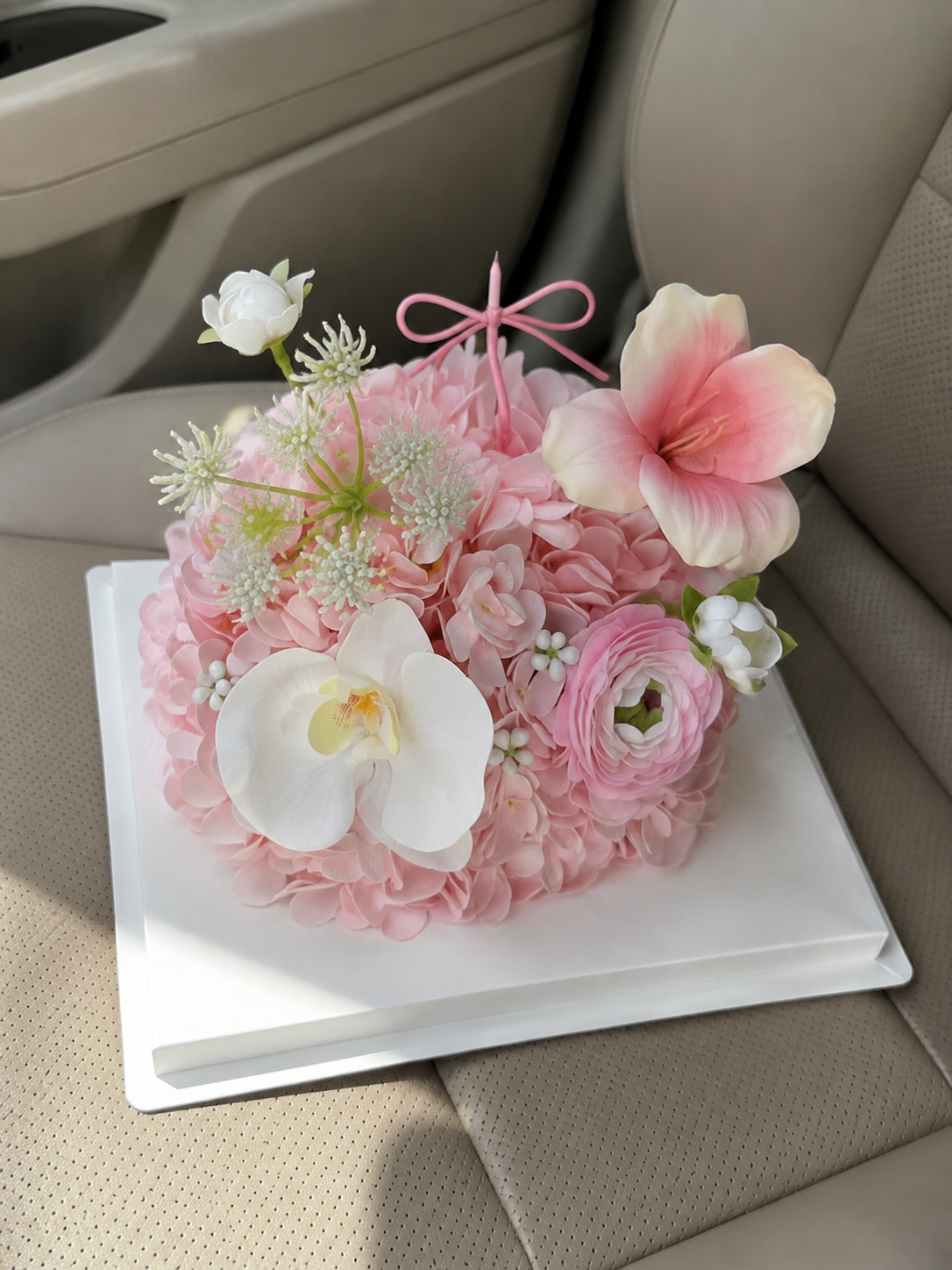 Petal Party Flower Cake – Blush Pink decorative flower cake, not edible – AI-assisted high-angle parked car view