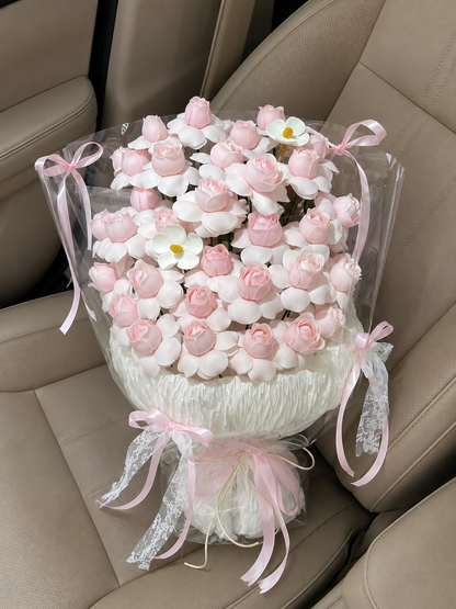 Pink Ivory Blossom Clear Wrap Bouquet – high-angle bouquet on parked car seat