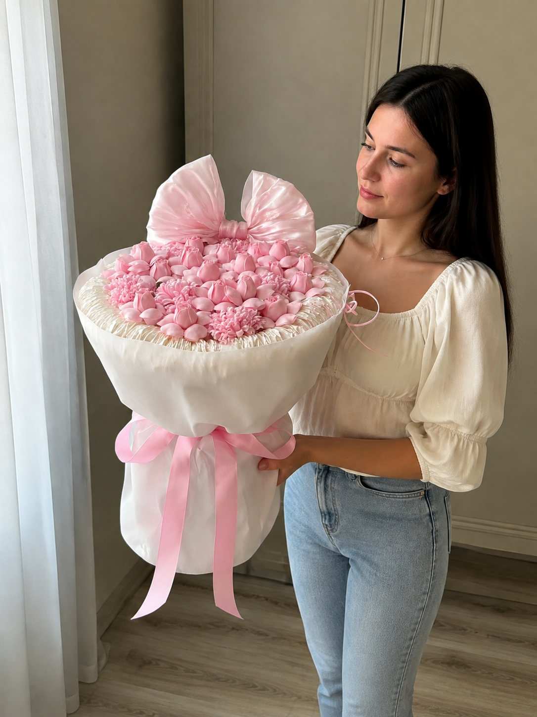 Pink Rosebud Bow Celebration Bouquet – the pictured pink rosebud and carnation design; size is illustrative – AI-assisted model-held angled view