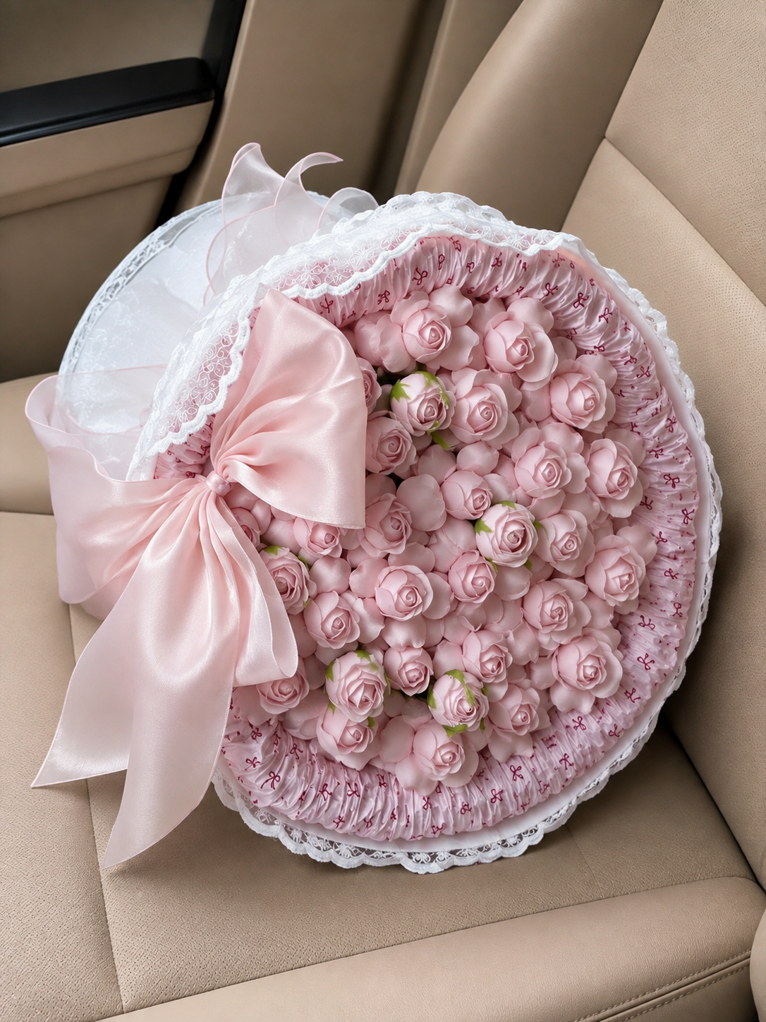 Pink Rosebud Satin Ruffle Bouquet – high-angle bouquet view on parked car seat