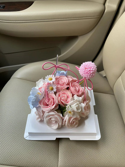 Petite Rose Celebration Flower Cake, Medium, high-angle car-seat view; AI lifestyle illustration