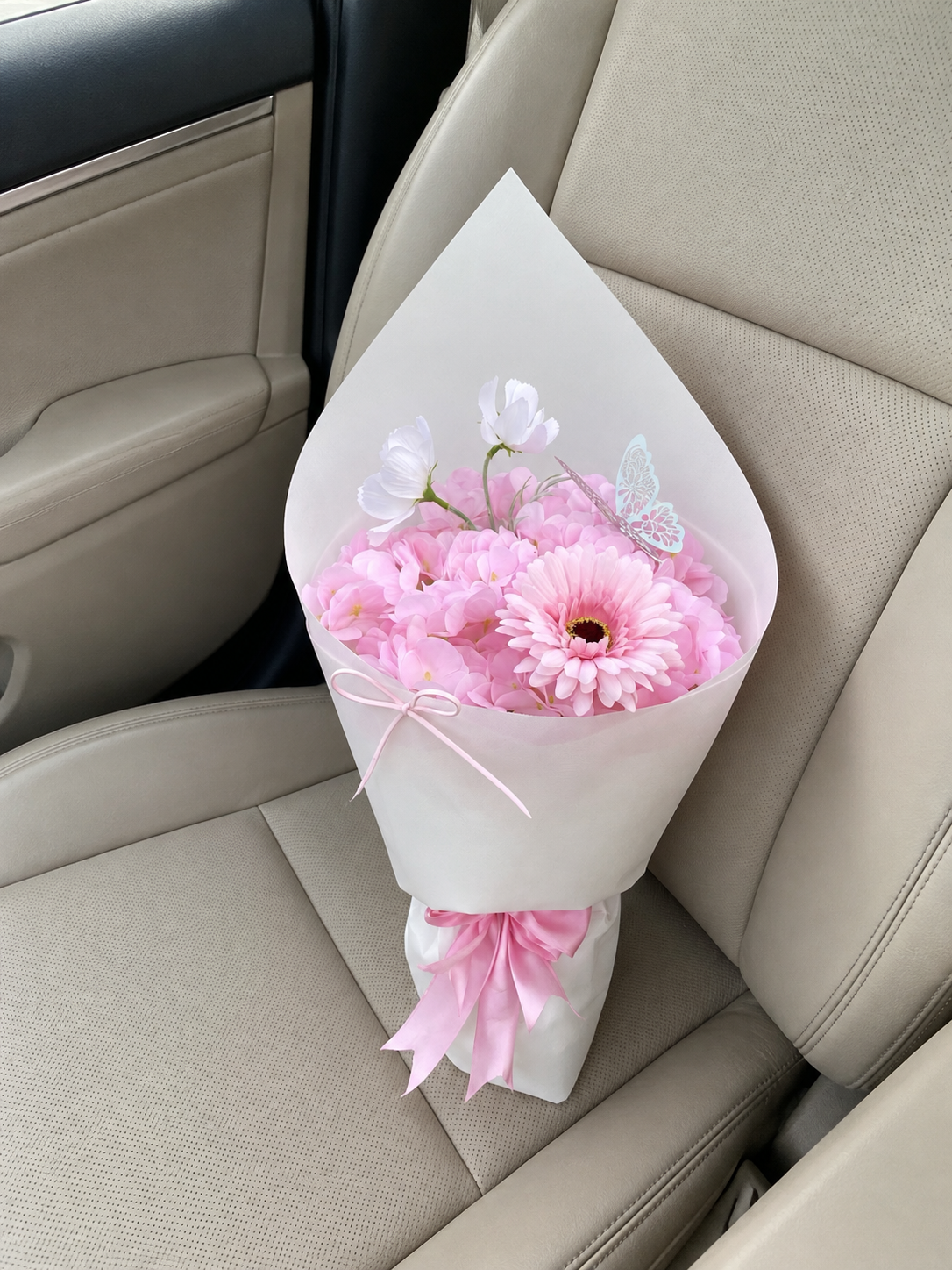 Pink Daisy Hydrangea Small Bouquet, high-angle car-seat view; AI lifestyle illustration