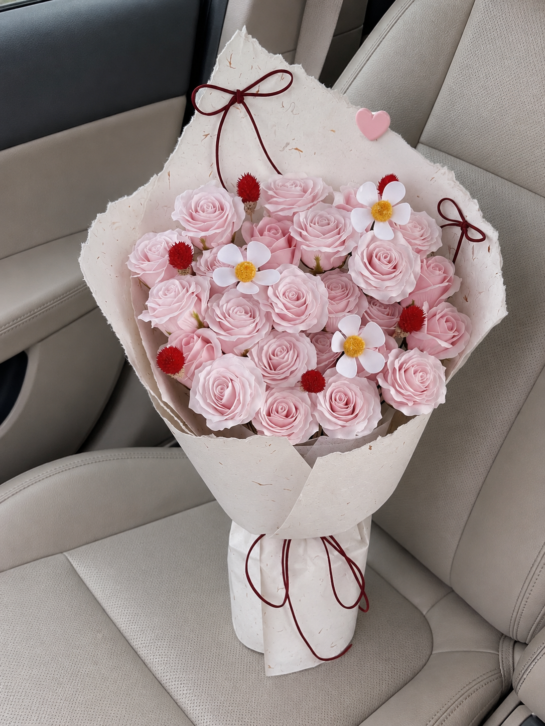 Pink Rose Daisy Burgundy Ribbon Bouquet, high-angle car view; AI design illustration