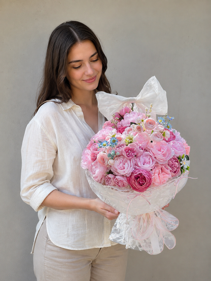 Pink Rose Garden Grande Bouquet, person-held angled view; AI design illustration