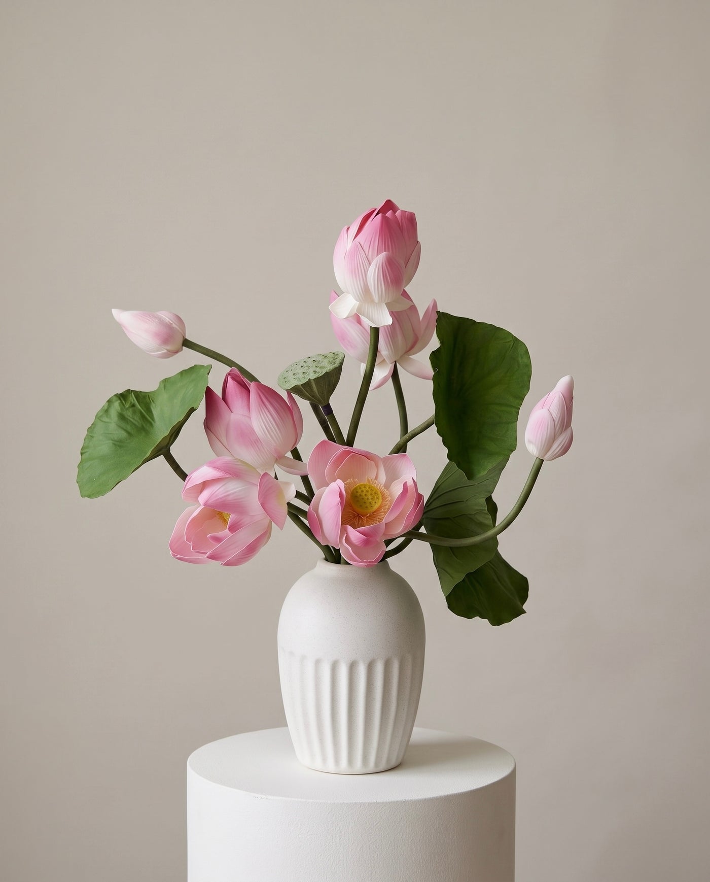 Sculptural lotus flower arrangement in a decorative vase